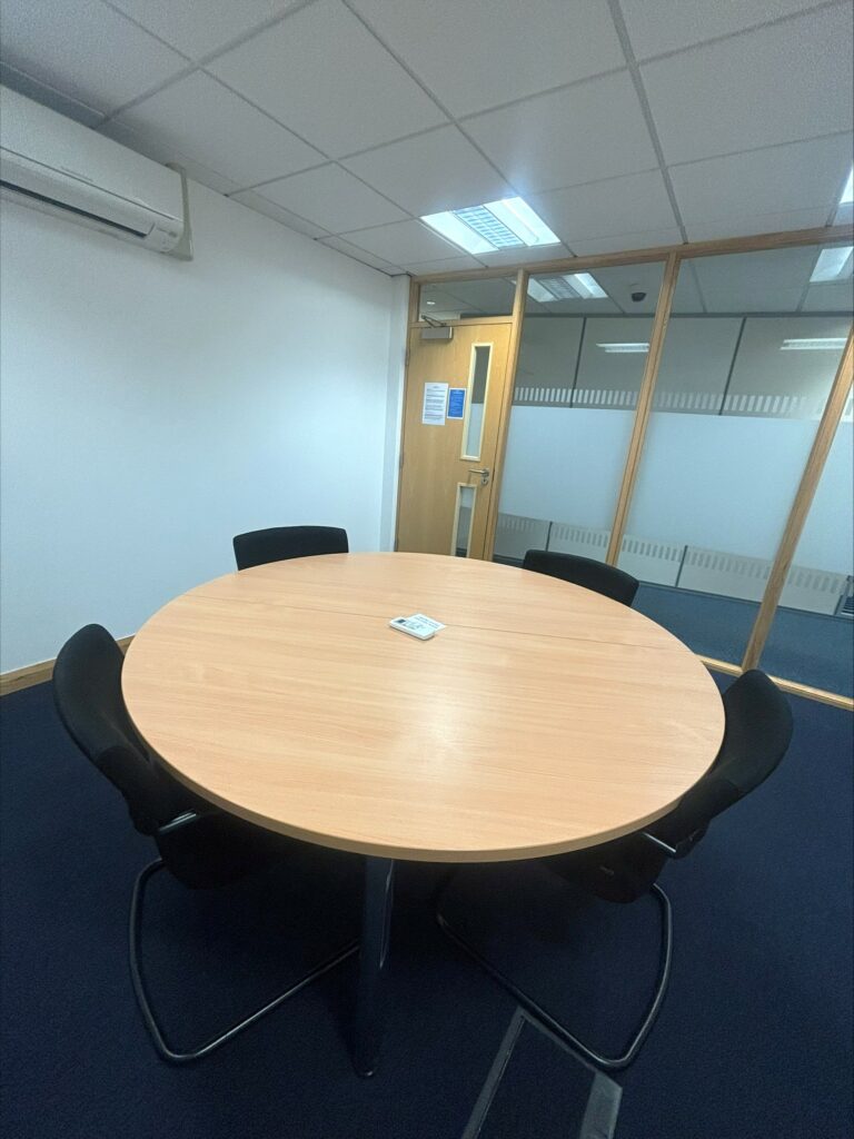 Small round table for up to 4 people. The rooms has ceiling to floor glass windows.