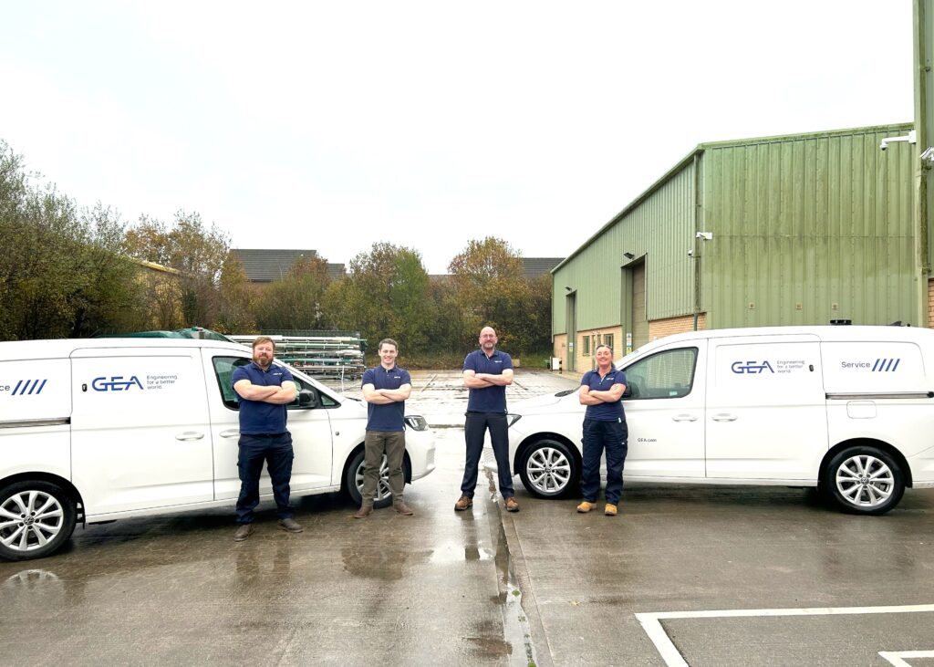 Picture of 4 team members from GEA stood outside next to their white vans